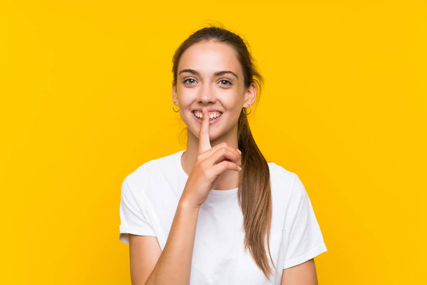 Young woman over isolated yellow background doing silence gesture - Фото, зображення