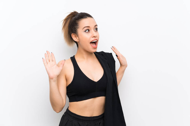 Young sport woman over white wall with surprise facial expression - Foto, Imagen