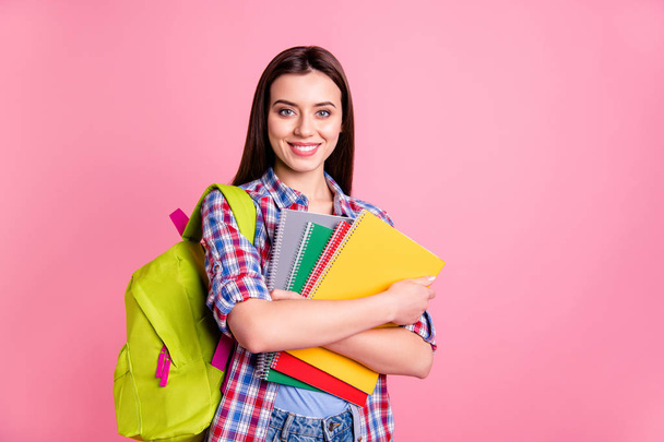Portrairt of cute nice pretty college teen teenager high school person people have textbooks want learn positive cheerful satisfied wear checkered plaid clothing isolated pastel pink background - 写真・画像