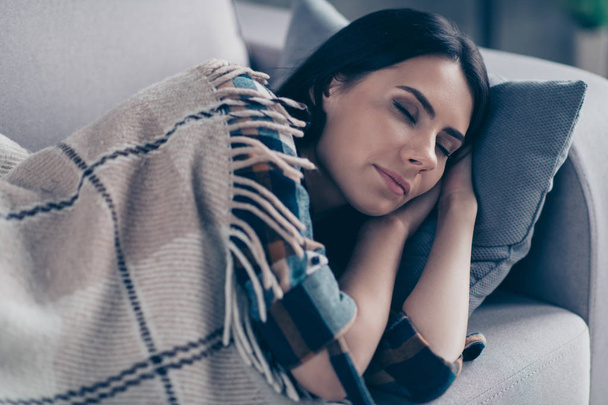 Close up photo beautiful she her lady fell asleep after dinner hands arms under head eyes closed dreaming covered blanket wear checkered plaid shirt lying comfy divan flat house living room indoors - Photo, Image