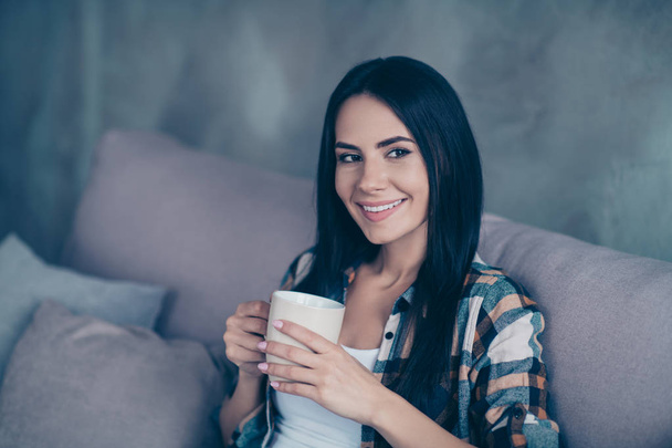 Close up side profile photo beautiful she her lady hands arms hot warm beverage wondered imaginary flight calm peaceful kindhearted wear checkered shirt sit cozy divan house living room indoors - Foto, afbeelding