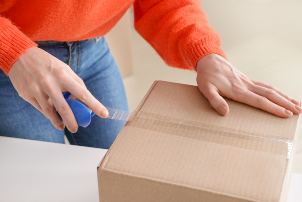 Young woman packing box, closeup - Photo, Image