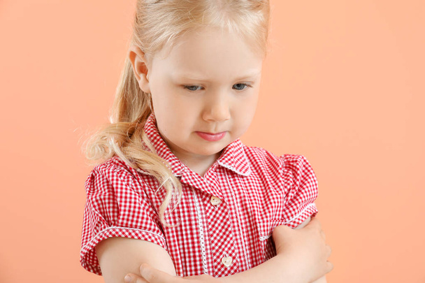 Porträt eines traurigen kleinen Mädchens auf farbigem Hintergrund - Foto, Bild