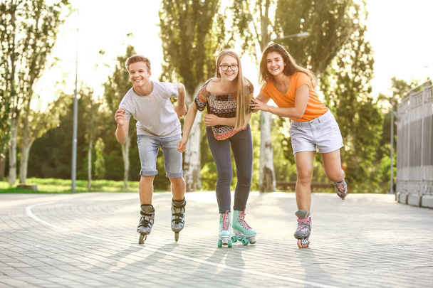 Teenagers on roller skates outdoors - Fotoğraf, Görsel