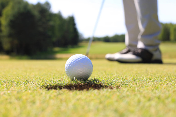 Joueur de golf à la balle frappante verte de mise dans un trou. - Photo, image