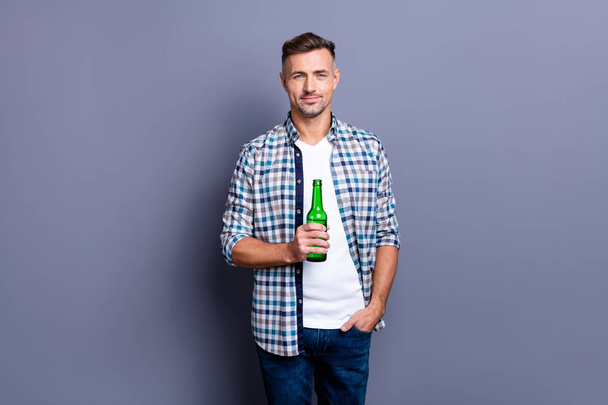 Portrait of his he nice attractive cheerful bearded guy wearing checked shirt holding in hand light beer bachelor isolated over gray blue violet purple pastel background - Valokuva, kuva