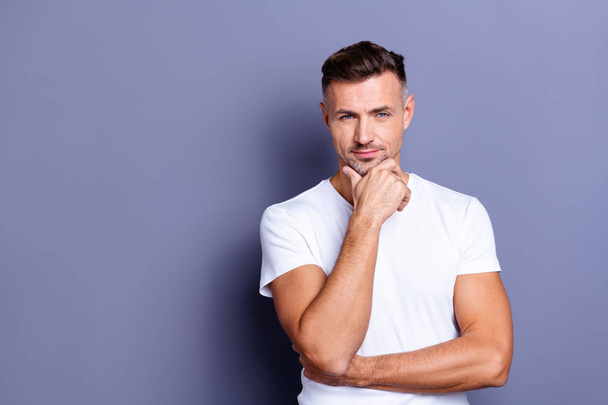 Close up photo amazing he him his middle age macho perfect appearance hand arm chin look pensive ponder doubtful unsure uncertain funny playful mood wear casual white t-shirt isolated grey background - Fotó, kép