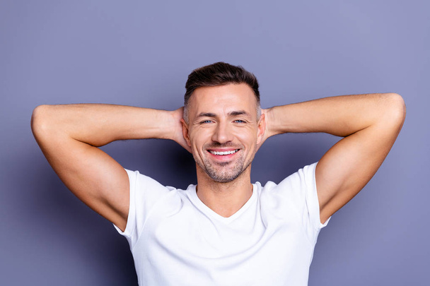Close up photo amazing he him his middle age macho perfect appearance teeth hands arms behind head overjoyed imaginary flight refreshment time wear casual white t-shirt isolated grey background - Foto, Imagem