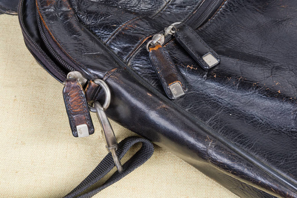 Фрагмент старої чорної шкіряної сумки з деякими аксесуарами сумки
 - Фото, зображення