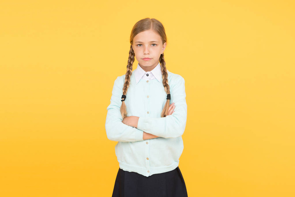 smart little girl on yellow background. education concept. back to school. unhappy girl in school uniform. knowledge day. childhood happiness. kid fashion. school market. Smart and confident student - 写真・画像