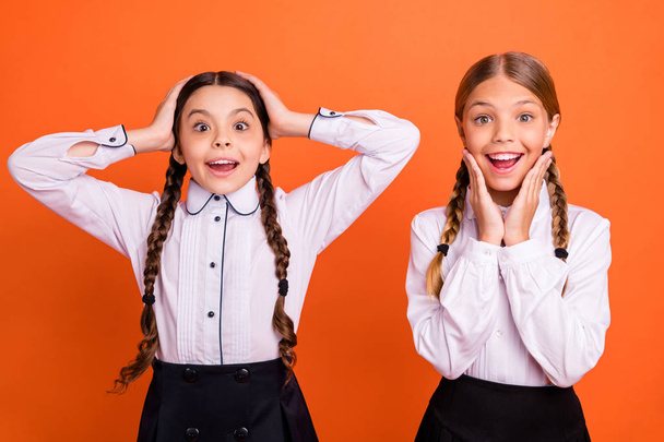 Portrait of nice attractive lovely winsome charming sweet cheerful cheery excited positive astonished pre-teen girls isolated over bright vivid shine orange background - Foto, Bild