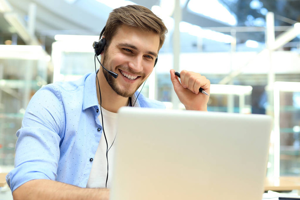 Happy young male customer support executive working in office. - Foto, Imagem