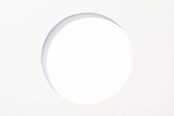 cut out round hole in white paper on white background - Photo, Image