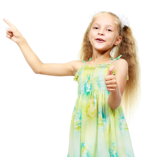 Маленька дівчинка в сукні, вказуючи пальцем
 - Фото, зображення