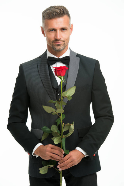 Valentines day and anniversary. Dating services. How to be romantic. Romantic gentleman. Man mature confident macho with romantic gift. Handsome guy rose flower romantic date. Perfectionist concept - Zdjęcie, obraz