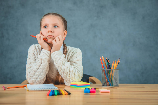 Shocked young pupil. Girl is wondering of homework quantity.Photo of schoolgirl isolated on grey background. - Foto, Bild