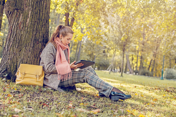 Véritable femme d'affaires avec tablette portable au travail en plein air dans le parc
 - Photo, image