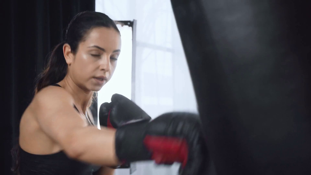 hermoso entrenamiento deportivo serio con saco de boxeo en el gimnasio
 - Metraje, vídeo