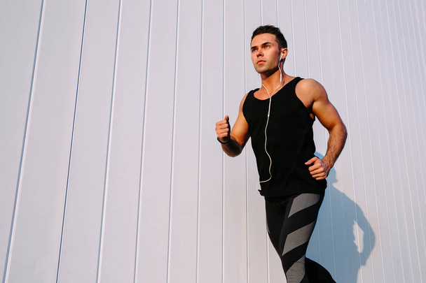 Confident sportsman running outdoors - Photo, Image