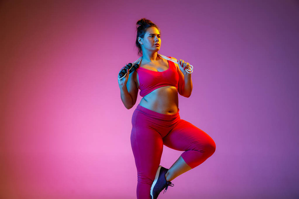 Young caucasian plus size female models training on gradient background - Foto, afbeelding