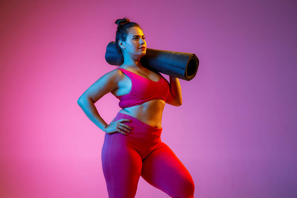 Young caucasian plus size female models training on gradient background - Photo, Image