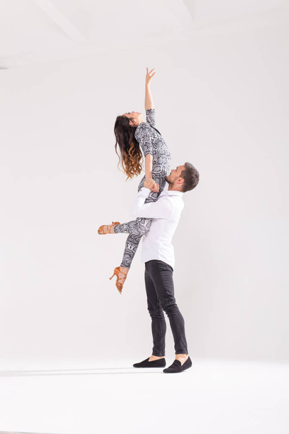 Social dance, bachata, kizomba, tango, salsa, people concept - Young couple dancing over white background - Фото, зображення