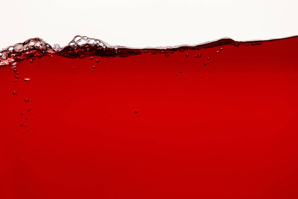 ripple red bright liquid with bubbles isolated on white - Фото, изображение