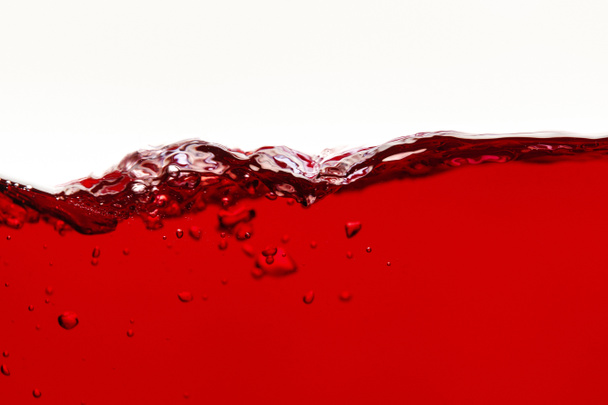 czerwona jasna płynna fala z bąbelkami wyizolowanymi na białym - Zdjęcie, obraz