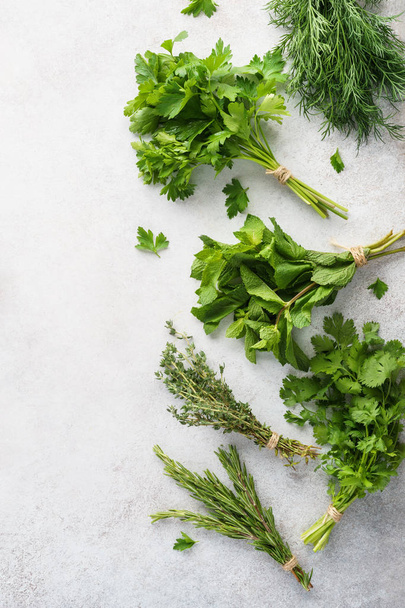 Fresh herbs on gray background. Various ingredients for cooking. - Foto, Imagem