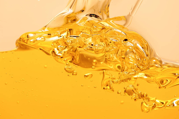 yellow bright liquid splash with bubbles isolated on yellow - Photo, Image