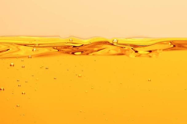 ripple yellow bright liquid with bubbles isolated on yellow - Φωτογραφία, εικόνα