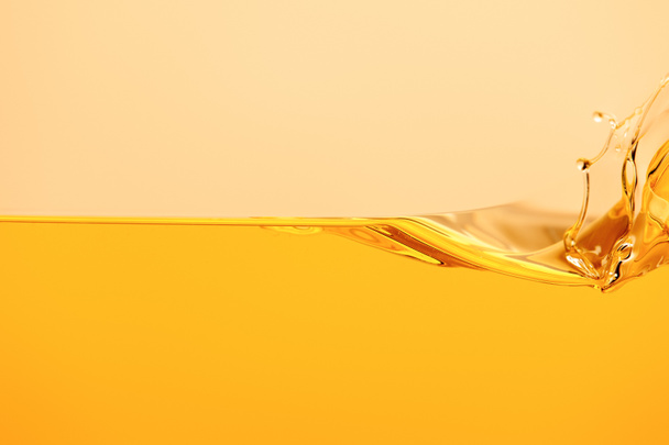 yellow bright liquid splash isolated on yellow - Photo, Image