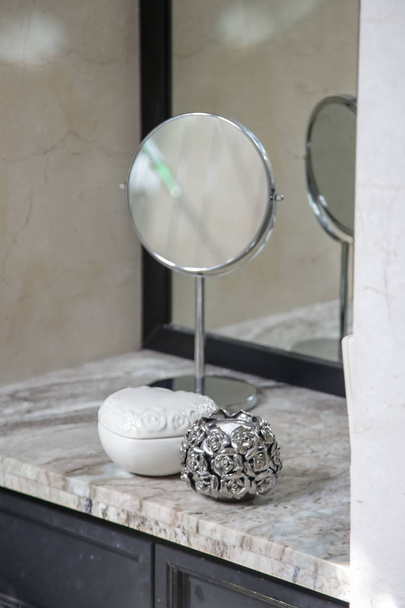 Vanity table, mirror and jewelry boxes on the elegant marble desk - Photo, image