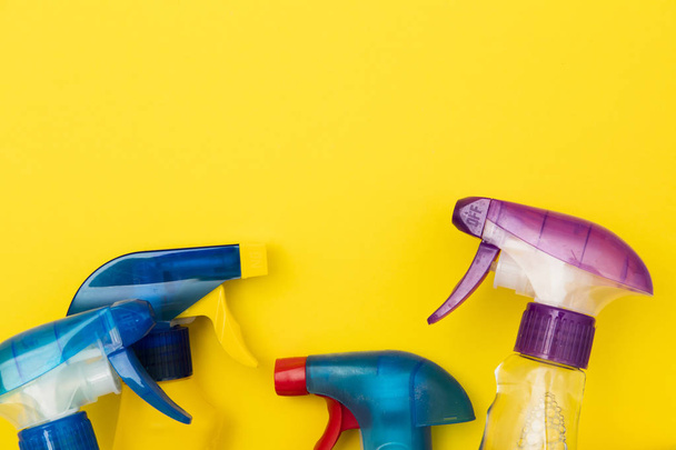 Cleaning spray bottle products on a bright yellow background - Fotografie, Obrázek