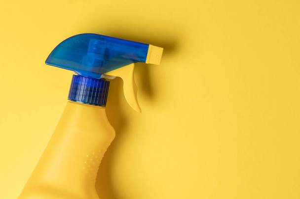 Cleaning spray bottle products on a bright yellow background - Fotoğraf, Görsel