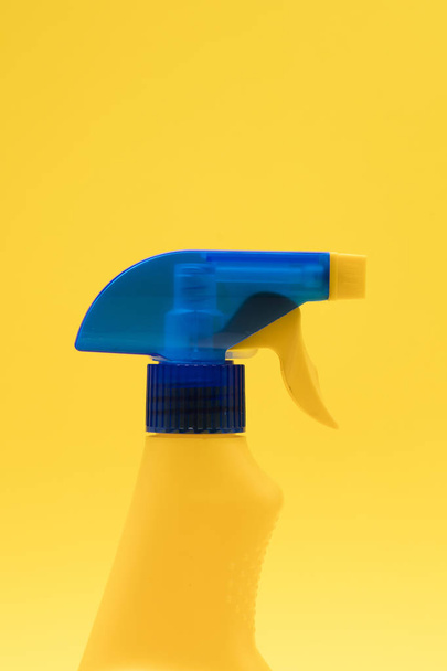 Cleaning spray bottle products on a bright yellow background - 写真・画像