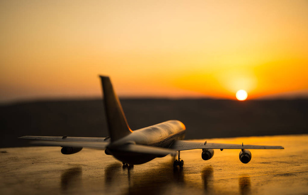 Decoração de obras de arte. Avião branco de passageiros pronto para decolar da pista do aeroporto. Silhueta de Aeronaves durante o pôr do sol
. - Foto, Imagem