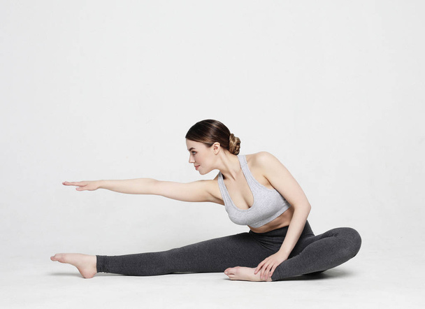 Portrait of attractive woman doing yoga, pilates. Healthy lifestyle and sports concept. - Photo, Image