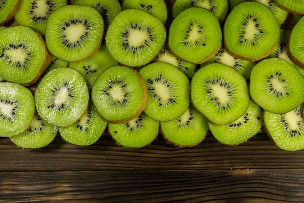 Sliced kiwi fruits on wooden table - Photo, Image