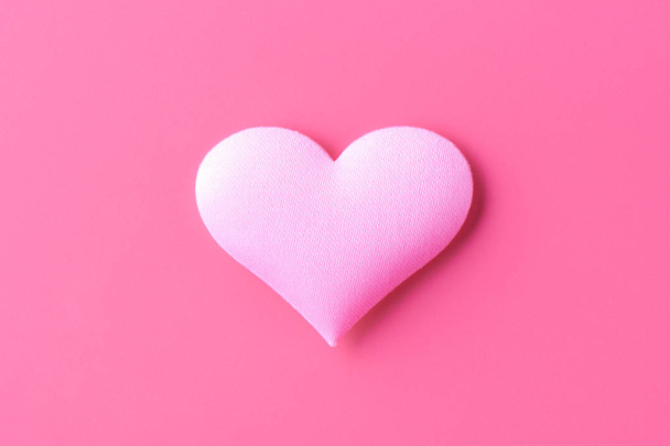 Volume heart on a pink background, a symbol of love and loyalty - Fotoğraf, Görsel