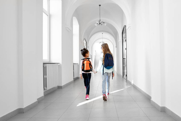 Back view of two girls going forward at school. - Foto, afbeelding