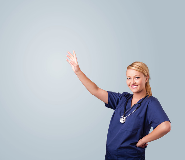 Young female doctor gesturing with copy space - Foto, Bild