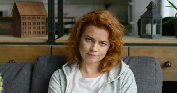 Portrait of young annoyed woman with red curly hair - Footage, Video