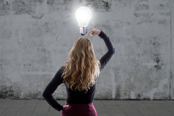 woman thinking with the light bulb on - Photo, Image