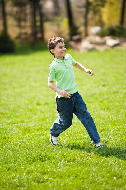 Boy running on a meadow - 写真・画像