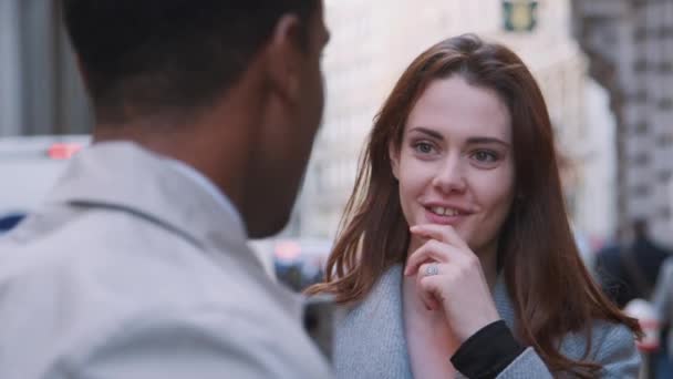 Two millennial business colleagues standing on a street in London having a conversation, selective focus, close up - Filmmaterial, Video
