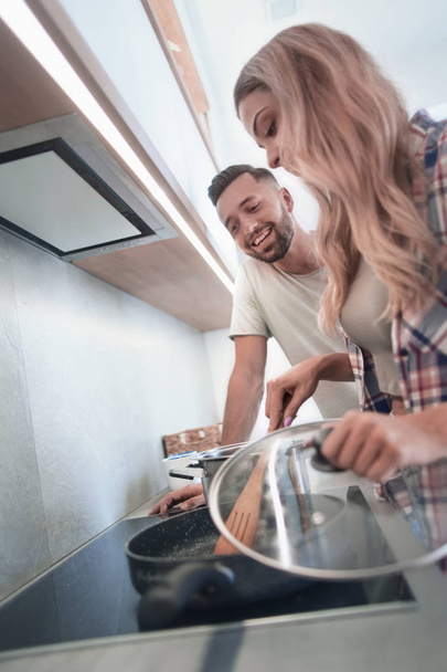 young husband and wife cook dinner together - Photo, image