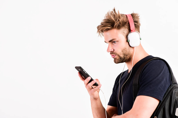earphones playing electronic sound. mp3 player. sexy muscular man listen music on phone mp3 player. man with mp3 player on phone isolated on white. unshaven man in headphones - Фото, изображение