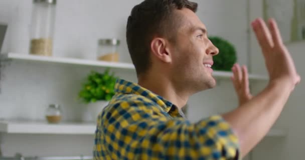 Young man is dancing in a modern kitchen - Filmagem, Vídeo