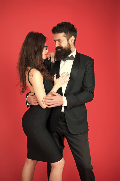 Elegance is not about being noticed. Award ceremony concept. Bearded man wear suit girl elegant dress. Formal dress code. Visiting event or ceremony. Couple ready for award ceremony. Corporate party - Photo, Image